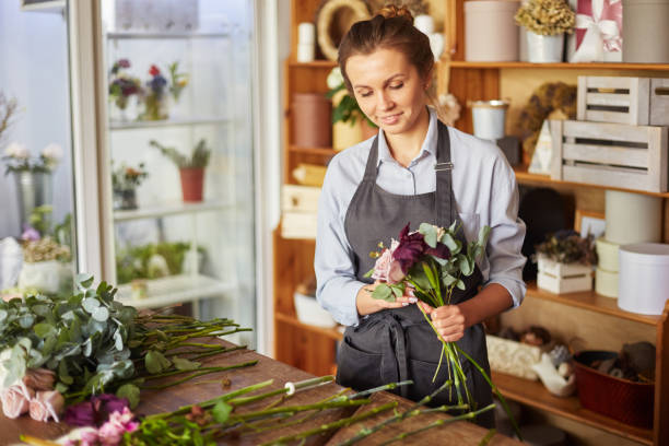 istock Florist busy making fresh pink bouquet 1421245760