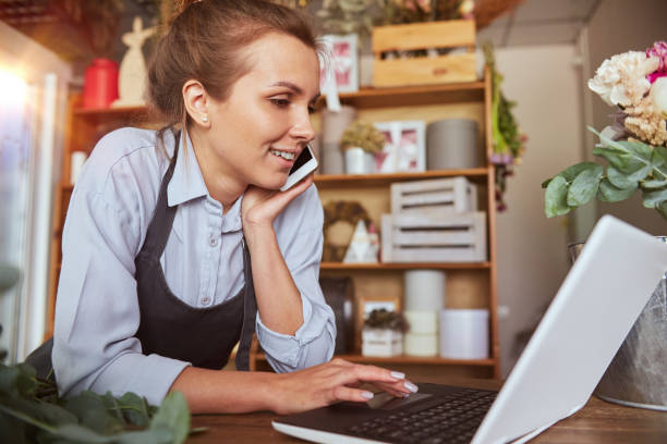 istock Florist busy at work with phone call 1421245800