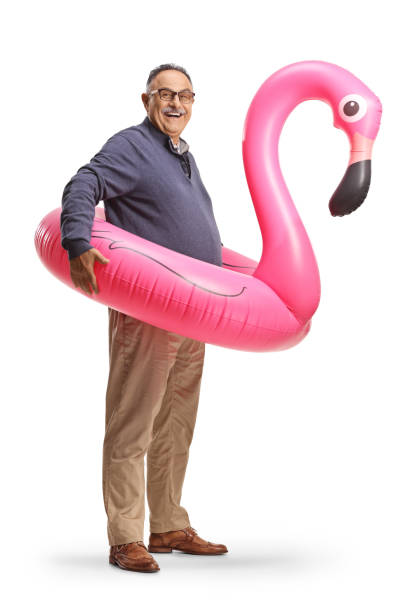 istock Mature man with a big inflatable flamingo rubber ring 1421247281