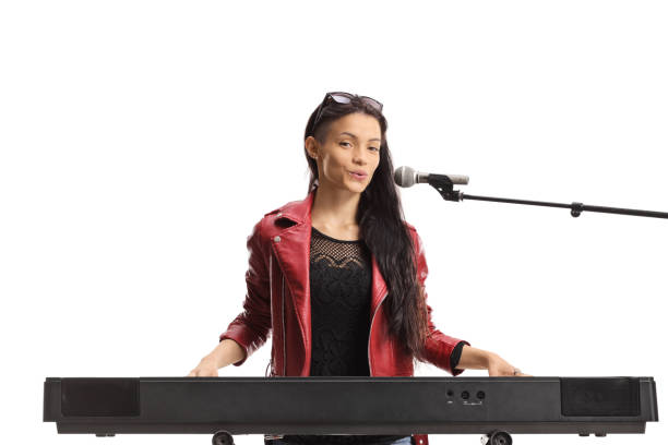 istock Young female musician playing a keyboard and singing 1421247785