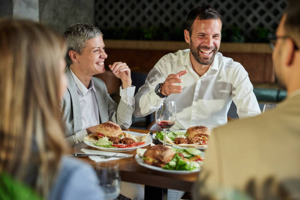 istock Cheerful business team having lunch in a restaurant. 1421248776