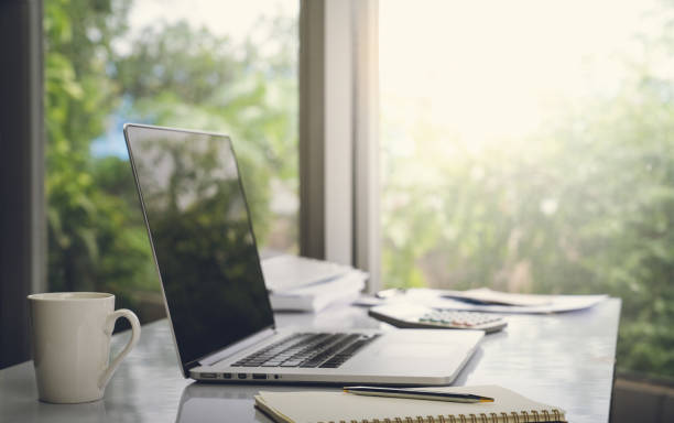 istock Top view desk of work table in office woth laptop computer , notebook , calculator and a cup of coffee for creative business work or marketing plan to success planning of company 1421256035