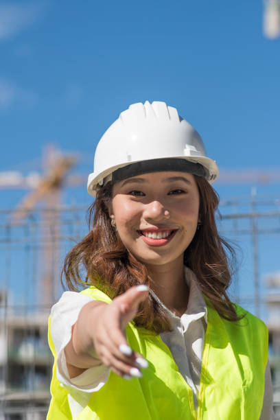 istock asian female construction manager working on the construction of a building 1421256726