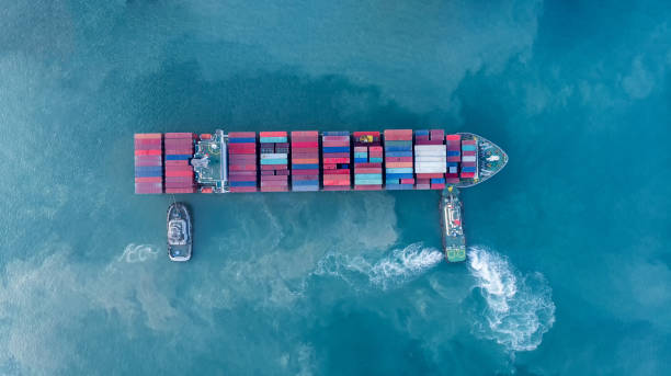 istock tug ship drag container ship vessel   to cargo international container yard port concept shipping by sea. 1421261684