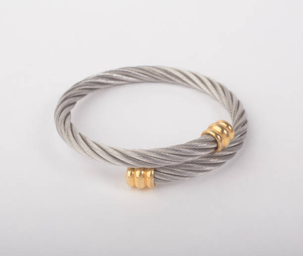 istock Spiral silver bangle decorated with golden 1421262862