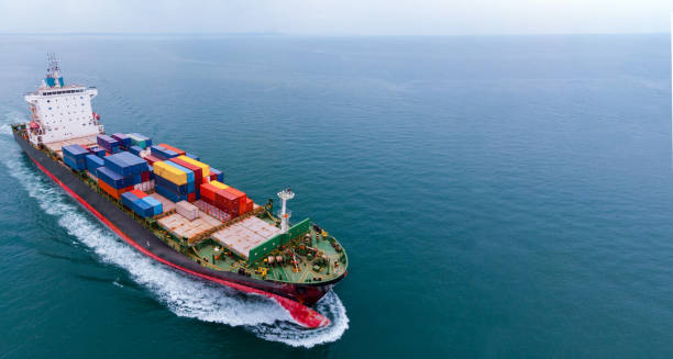 istock Aerial infront of cargo ship carrying container and running for export  goods  from  cargo yard port to custom ocean concept freight shipping by ship . 1421265954