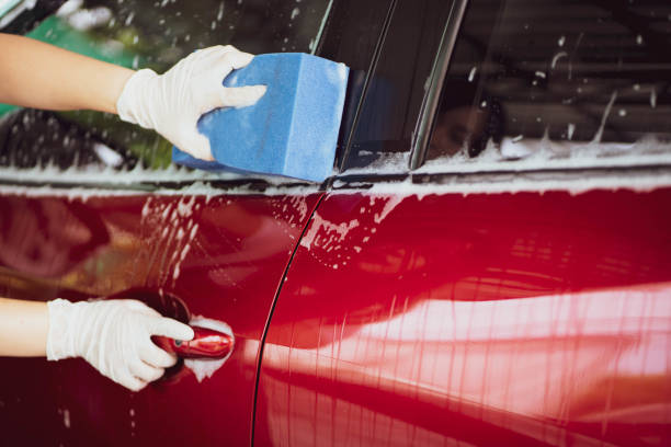 istock Unrecognizable woman washing a car. 1421266155