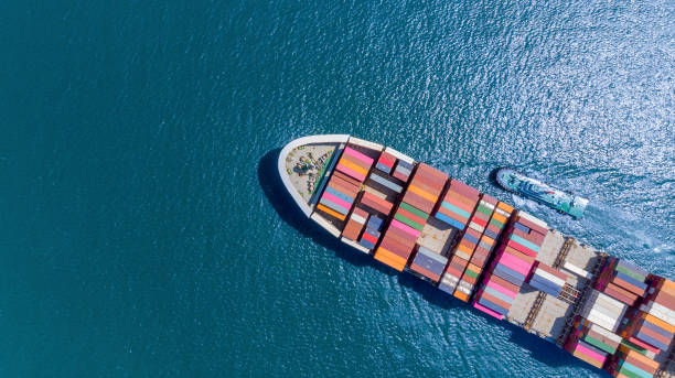 istock Aerial top view of cargo ship carrying container and running for export  goods  from  cargo yard port to custom ocean concept freight shipping by ship . 1421266202