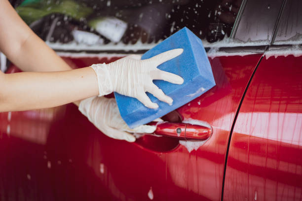 istock Unrecognizable woman washing a car. 1421266219