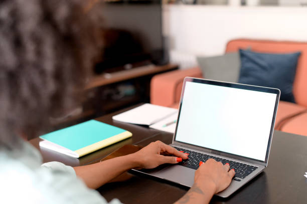istock Female student using laptop for watching webinars, lectures, sits at desk in home office and taking notes, eastern woman taking a part in online educational course, researching topic 1421266658