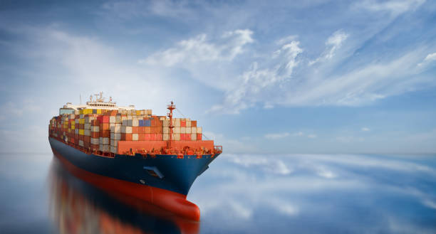 istock Aerial side view of smart cargo ship carrying container from custom container depot go to ocean concept freight shipping by ship service on blue sky background. 1421266949