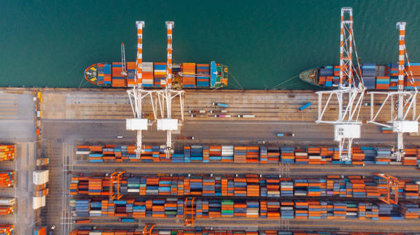 istock Smart crane loanding cargo container to container ship in the international terminal depot sea yard port concept freight shipping by ship. 1421268128