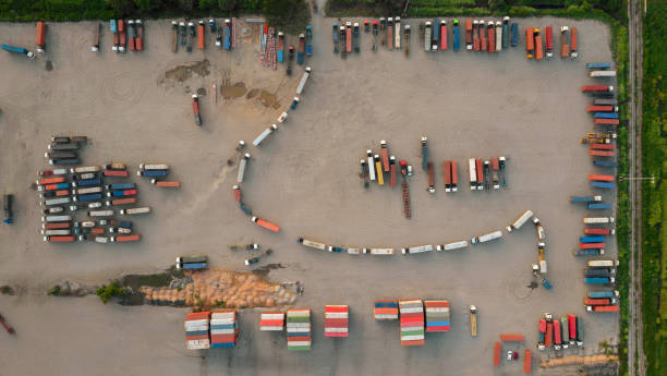 Aerial top view of many truck supply chain line carry cargo container , cargo truck for transportation import and export to merchant. Aerial top view of many truck supply chain line carry cargo container , cargo truck for transportation import and export to merchant. merchants gate stock pictures, royalty-free photos & images