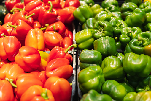 lettuce peppers of red and green color, in the supermarket for sale. The pepper is beautifully laid out on the counter. The concept of healthy eating and veganism. High quality photo