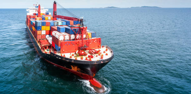 istock Aerial side view of cargo ship carrying container and running for export  goods  from  cargo yard port to other ocean concept freight shipping ship . 1421268946