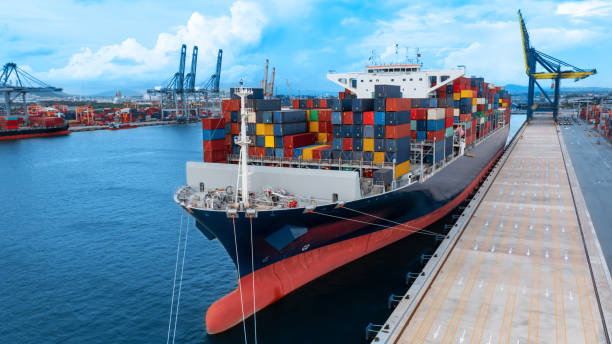 istock Cargo container ship at the international terminal container depot yard port concept freight shipping transportation and smart logistic technology service. 1421269035