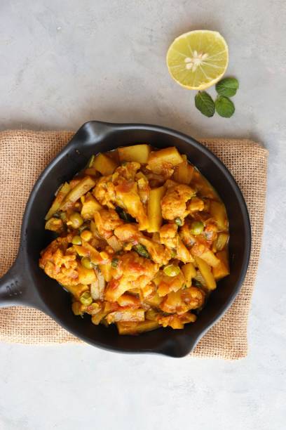 istock Aloo Gobi Mutter curry, cauliflower, and peas curry. Aloo Gobi masala. Served with wheat roti. famous Indian curry dish with potatoes and green peas. Copy space 1421269347