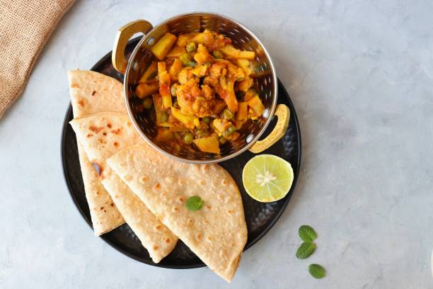 istock Aloo Gobi Mutter curry, cauliflower, and peas curry. Aloo Gobi masala. Served with wheat roti. famous Indian curry dish with potatoes and green peas. Copy space 1421269468