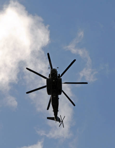 Helicopter belonging to the Dutch Royal Airforce (Koninklijke Luchtmacht) flying over the Meuse River in Den Bosch ('s-Hertogenbosch), at the nature resource Maasuiterwaarden.