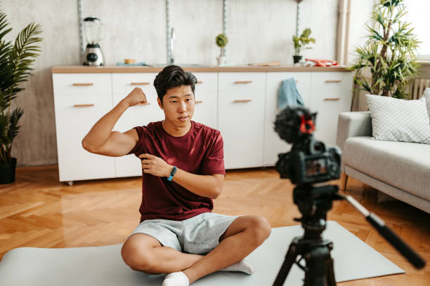 istock Young Man Filming A Vlog On Exercising At Home 1421271358