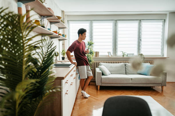 istock Young Man Drinking Water After Exercising At Home 1421271440