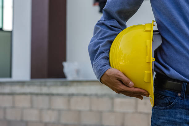 istock Engineer holding hard hat construction worker professional safety work industry building person manager service 1421272309