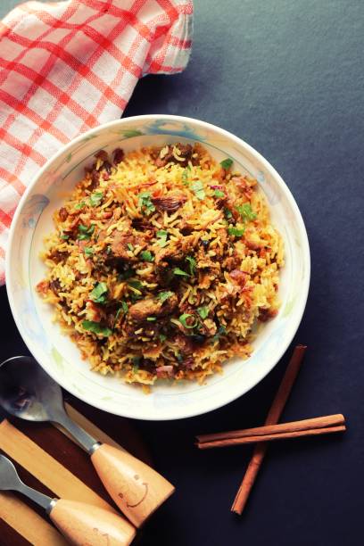 istock Mutton Biryani or Lamb Pulao. Garnished with fried onion & chopped coriander. Biryani is a famous Spicy non vegetarian dish of India. Goat meat cooked along with Basmati rice & spices. 1421273663