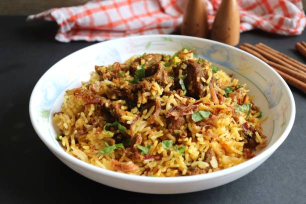 istock Mutton Biryani or Lamb Pulao. Garnished with fried onion & chopped coriander. Biryani is a famous Spicy non vegetarian dish of India. Goat meat cooked along with Basmati rice & spices. 1421273998