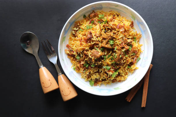 istock Mutton Biryani or Lamb Pulao. Garnished with fried onion & chopped coriander. Biryani is a famous Spicy non vegetarian dish of India. Goat meat cooked along with Basmati rice & spices. 1421274333