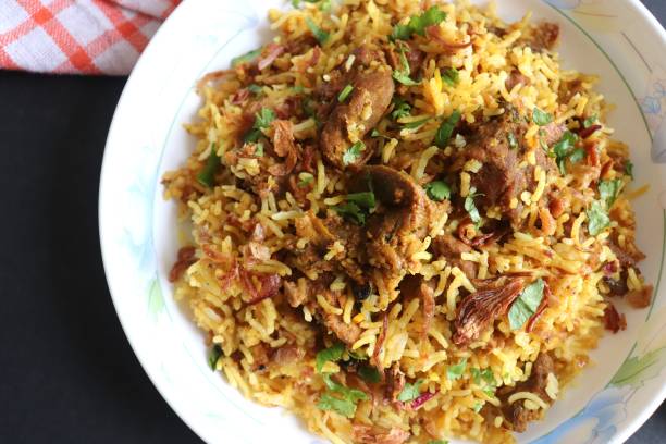 istock Mutton Biryani or Lamb Pulao. Garnished with fried onion & chopped coriander. Biryani is a famous Spicy non vegetarian dish of India. Goat meat cooked along with Basmati rice & spices. 1421274401