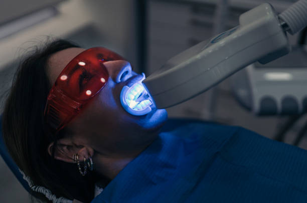 istock Woman Doing Tooth Whitening Treatment 1421278682