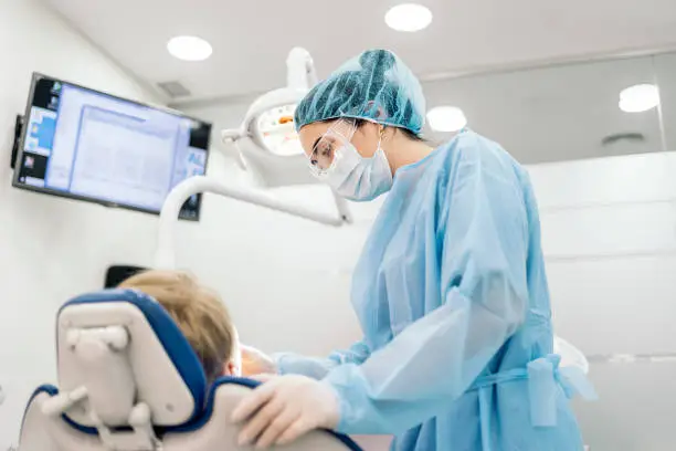 Photo of Female Dentist Working with Patient