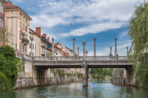 Ljubljana: View of the Cobblers' Bridge (Šuštarski most) in old city center,from river Ljubljanica.It is decorated by the Corinthian pillars and the Ionic pillars as lamp-bearers