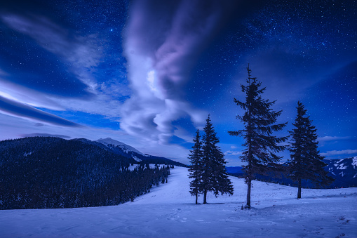 Winter in Carpathian mountains. Colorful night landscape in the highlands, Happy New Year celebration concept.
