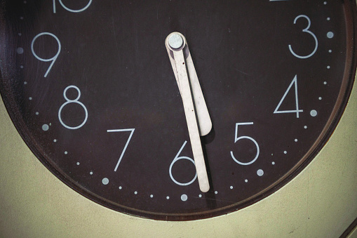 Round wall clock showing 17:27. - stock photo