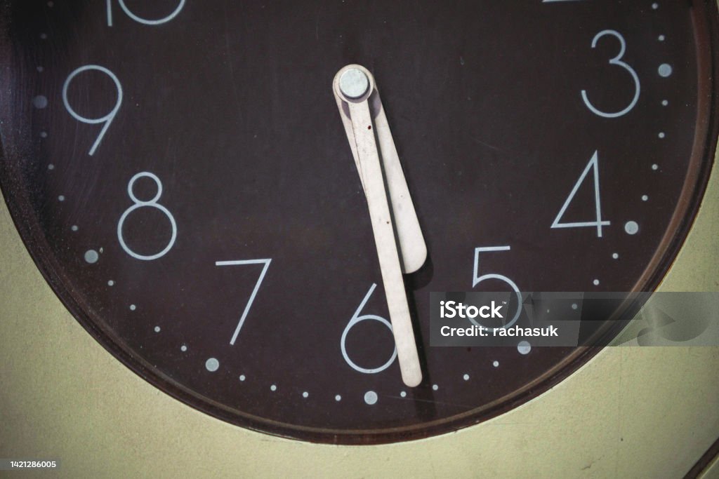 Round wall clock showing 17:27. - stock photo Occupation Stock Photo