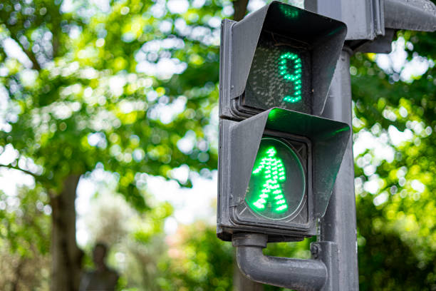 istock green traffic light to control pedestrian crossing with a countdown to 9 second. 1421286162
