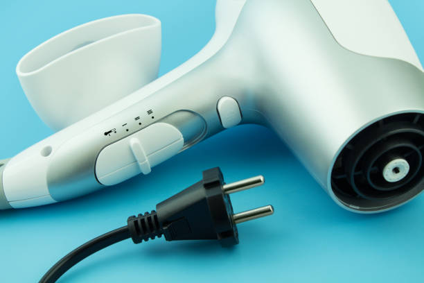 istock White Hairdryer and cable on blue background close up 1421286983