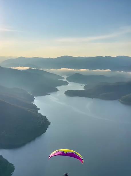 istock Enjoy the view of the dam with a paramotor. 1421287260