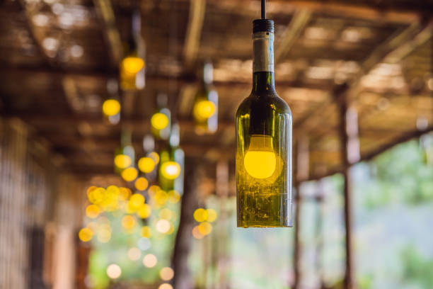 istock Beautiful retro light lamp decor made of empty wine bottles. Toned 1421288167