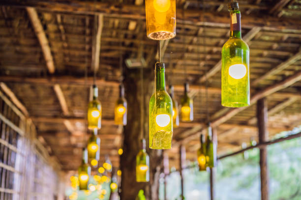 istock Beautiful retro light lamp decor made of empty wine bottles. Toned 1421288175