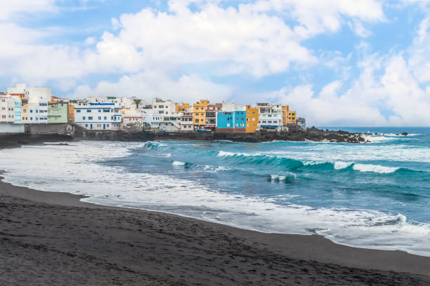 Wave crests with white foam on the surface of the turquoise water of the Atlantic Ocean on Playa Grande beach in Puerto de la Cruz, Spain stock photo