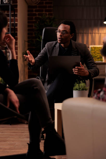 istock Young psychotherapist explaining psychological issues to people 1421294019