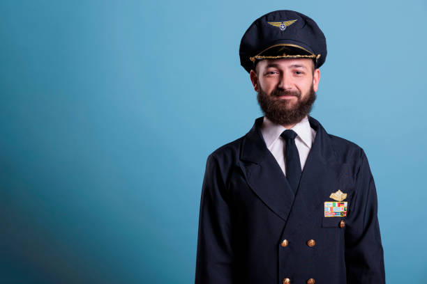istock Smiling airplane pilot wearing uniform front view portrait 1421295172