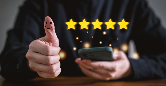 Customer using smart phone and laptop to rate their satisfaction ranking for experience review survey and comment