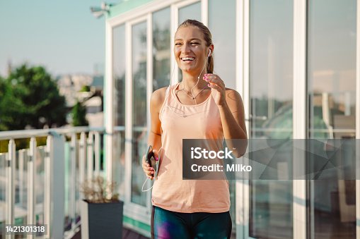 istock Young woman running in the city 1421301318