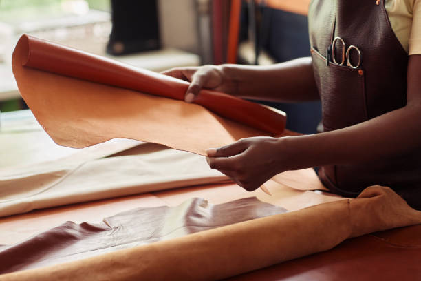 female artisan choosing leather closeup - manual worker sewing women tailor imagens e fotografias de stock