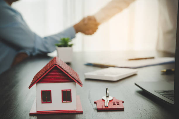 Estate agent shaking hands with client after contract signature and done business deal for transfer right of property. Man broker Real Estate Agent real estate agent shake hands of happy clients homeowners stock photo
