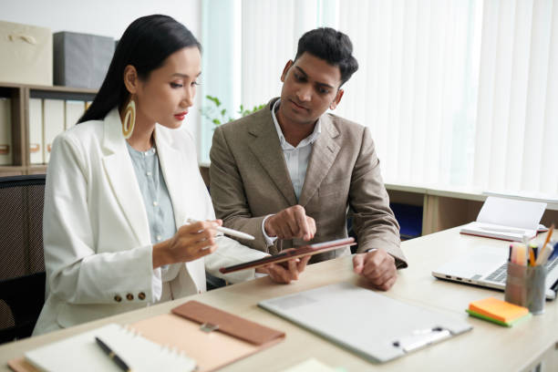 istock Business Colleagues Signing Agreement 1421304361