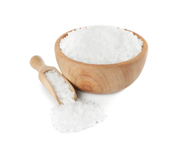 istock Wooden bowl and scoop with salt on white background 1421305619